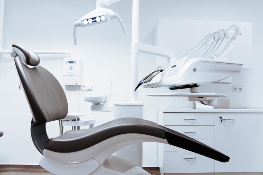 A dental treatment chair in a bright room